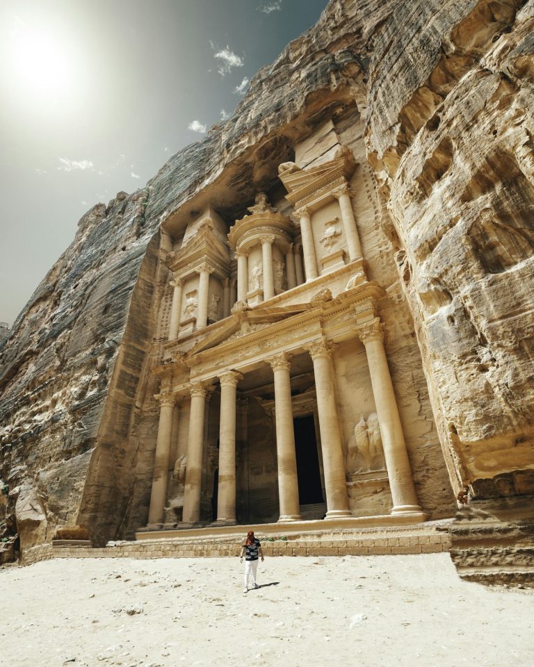 Explore Petra's iconic Treasury in bright sunlight, a symbol of ancient Jordanian architecture and history.